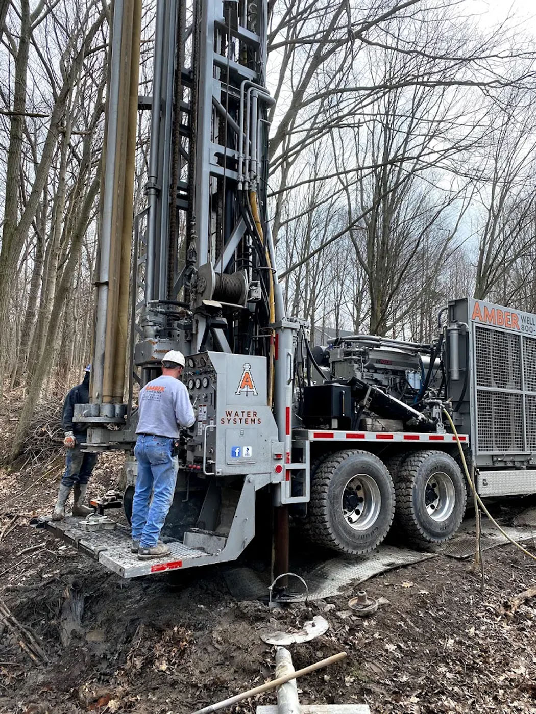 Two Amber Water Pros trucks on their way to install commercial water pumps.